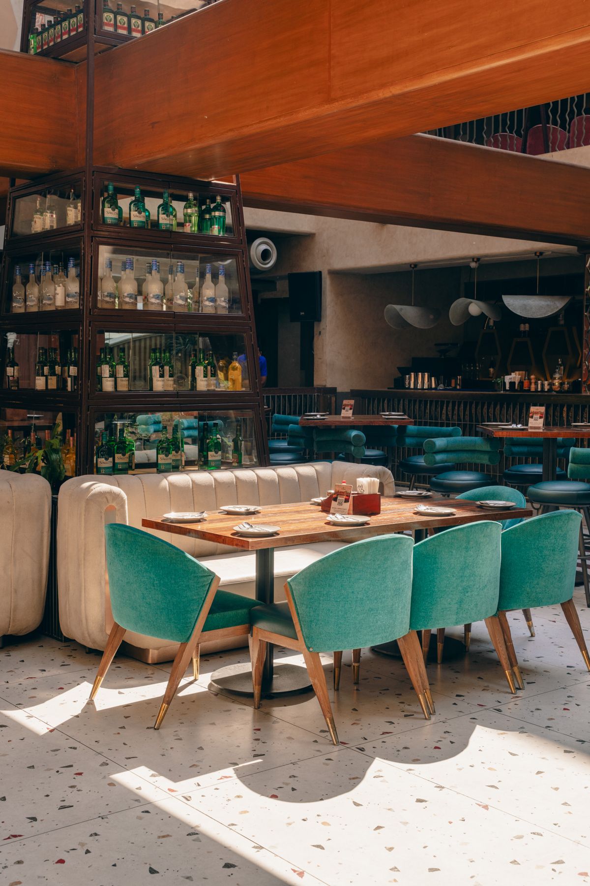 Ground floor with teal chairs and the bottle tower